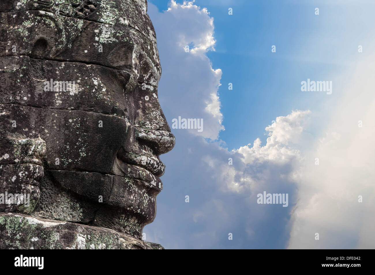 A fragment of the towers of the temple of Angkor Thom with the image of the Buddha Stock Photo