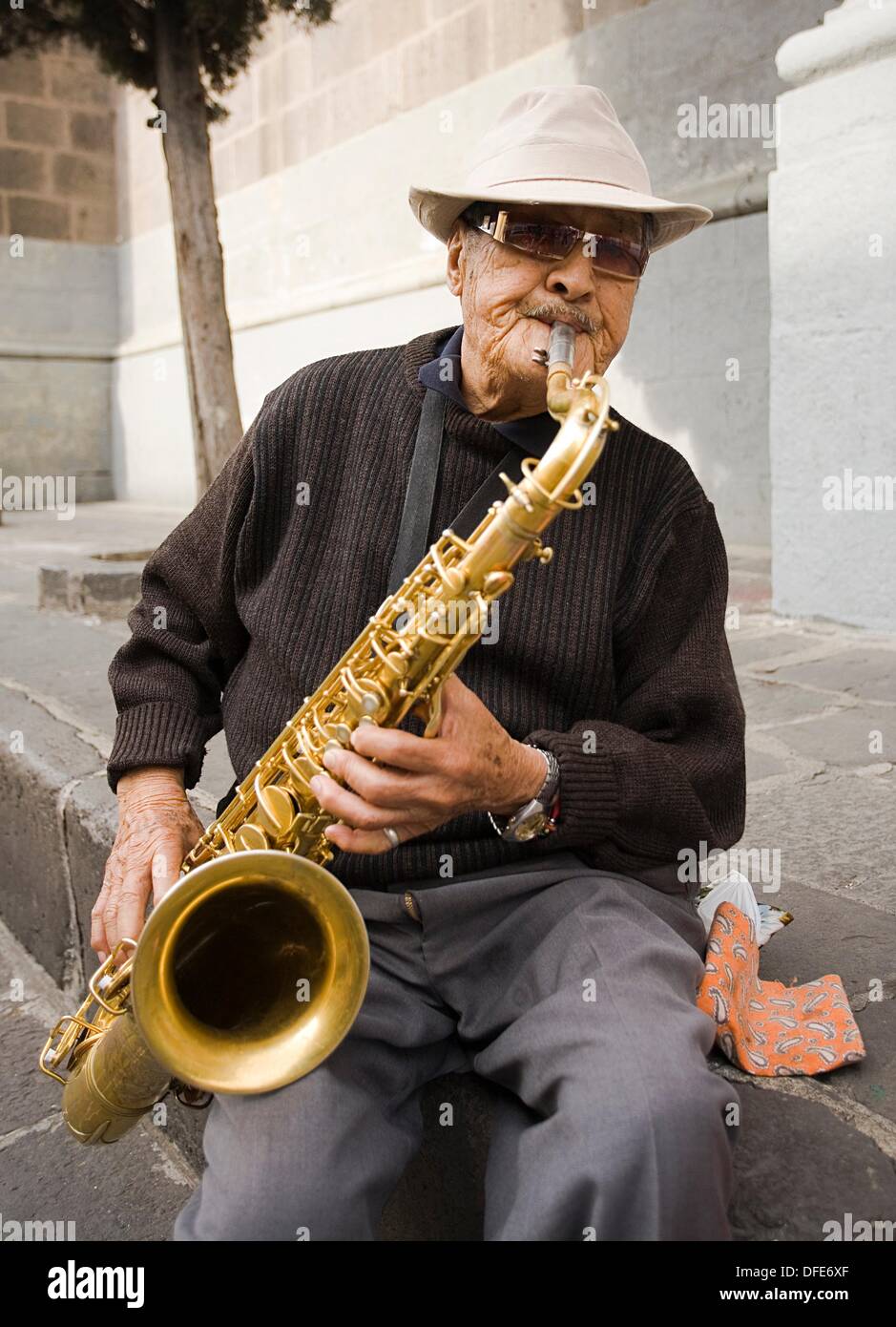 Old man playing saxo on the street, Puebla. Mexico Stock Photo - Alamy
