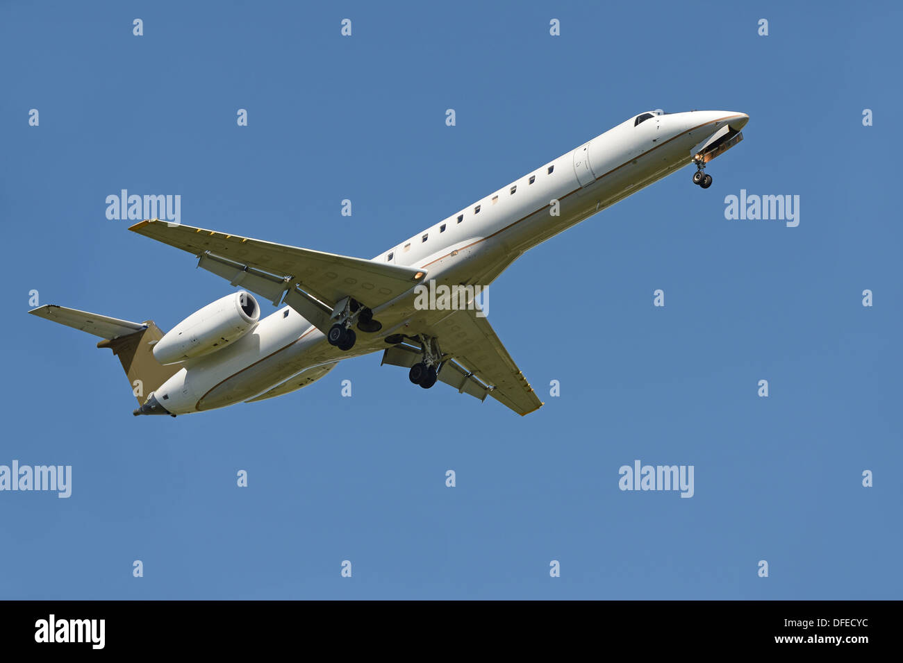 Commercial airliner landing over blue sky Stock Photo