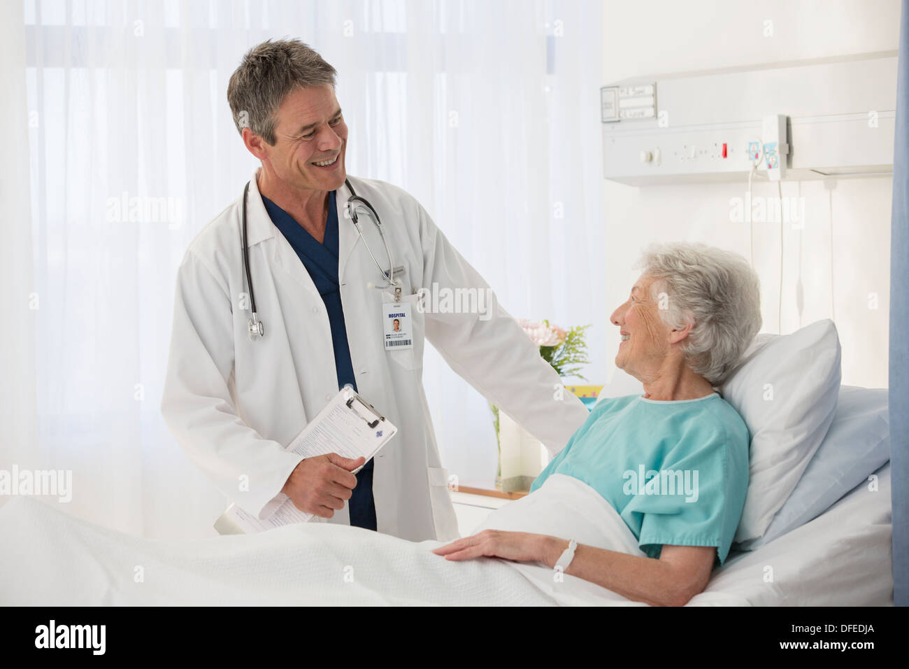 Doctor talking to elderly patient in hospital Stock Photo