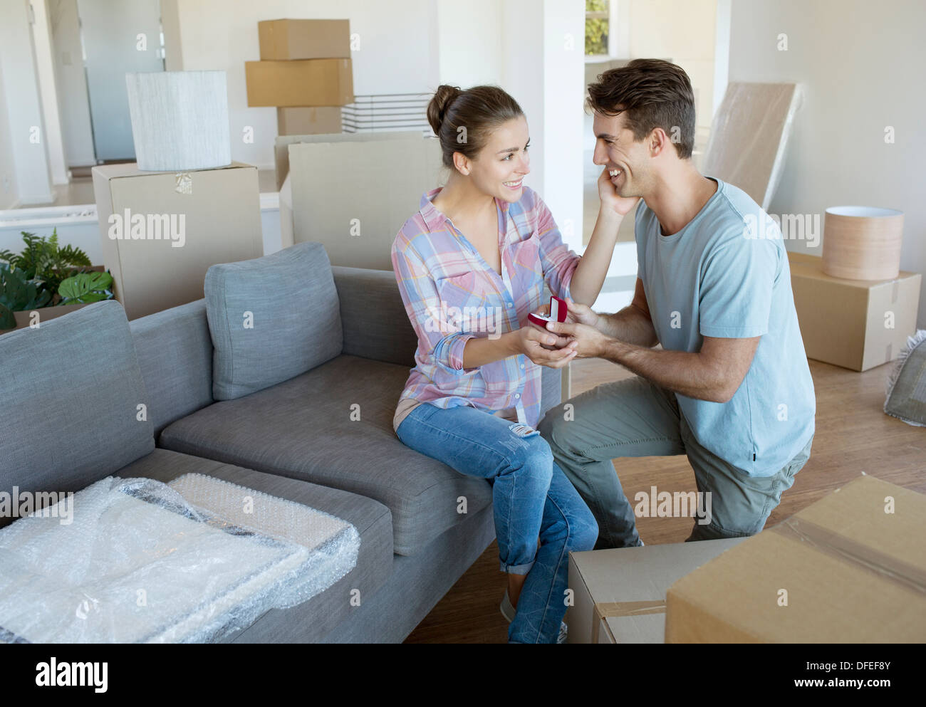 Man proposing to girlfriend in new house Stock Photo