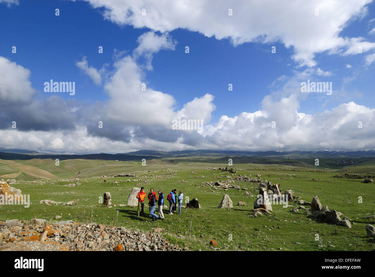 tourist group at Zorats Karer, 6000 B.C. stoneage observatory, menhir of Karahunj, Cara Hunge, Armenia, Asia Stock Photo