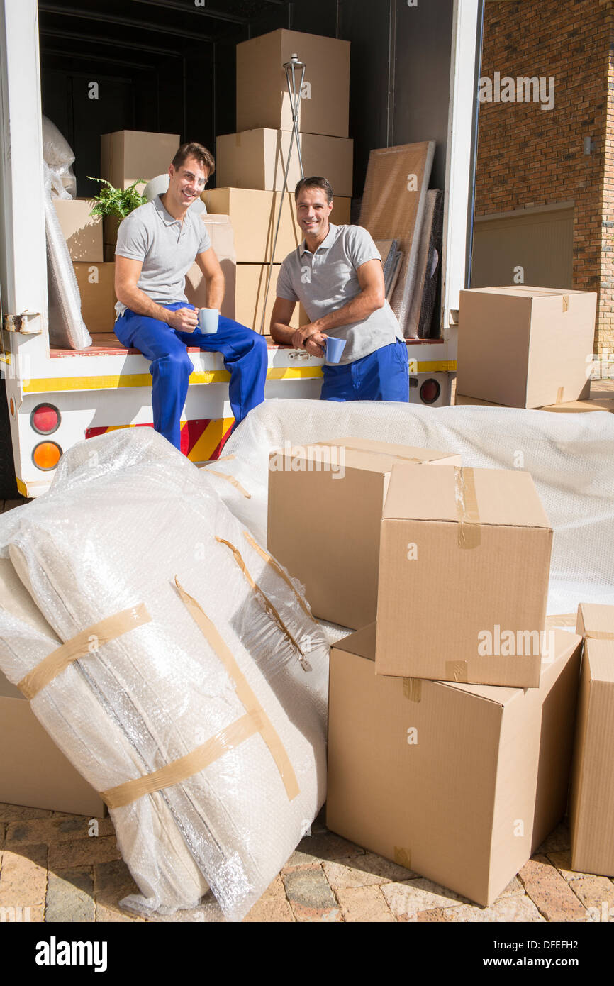 Movers sitting in moving van in driveway Stock Photo