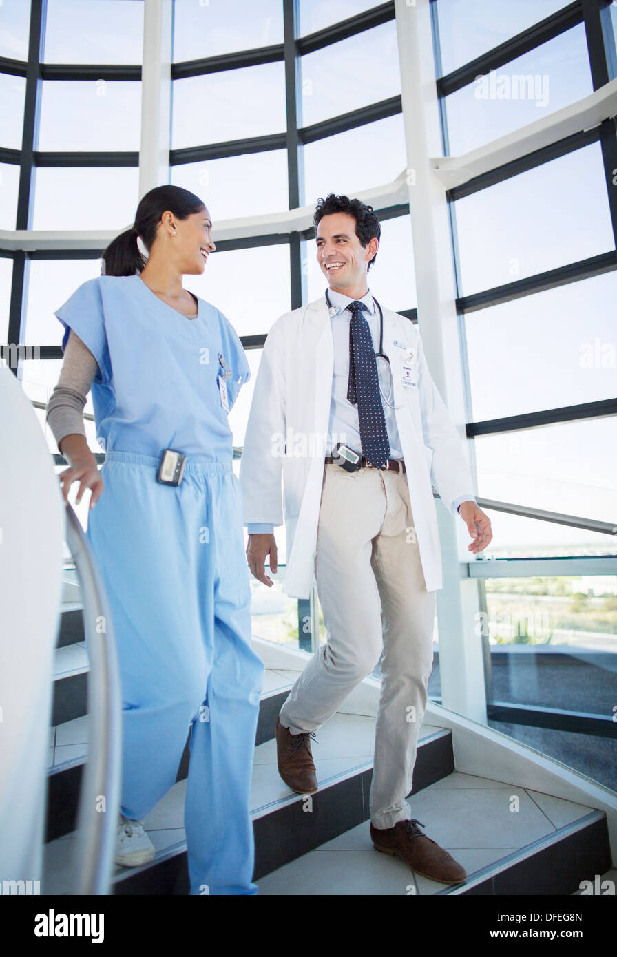 Doctor and nurse talking on staircase Stock Photo