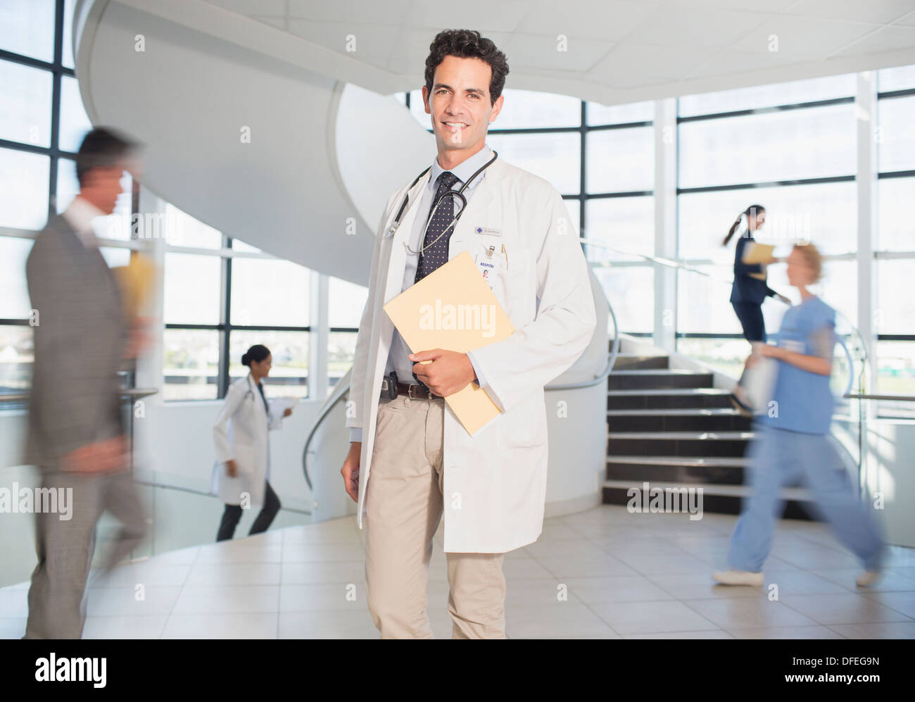 Doctor carrying folders in hospital Stock Photo