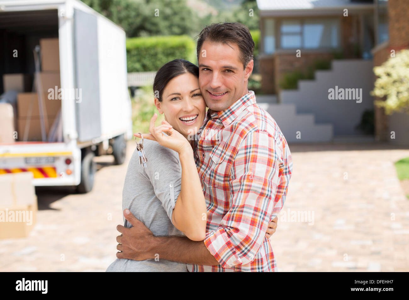 Portrait of smiling couple in front of new house Stock Photo