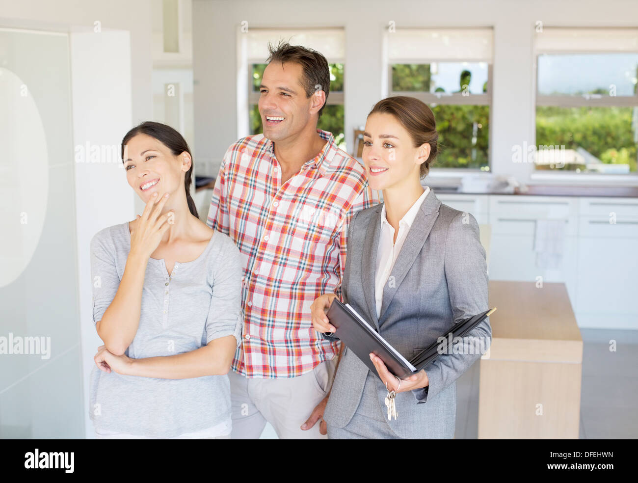 Realtor showing couple house Stock Photo