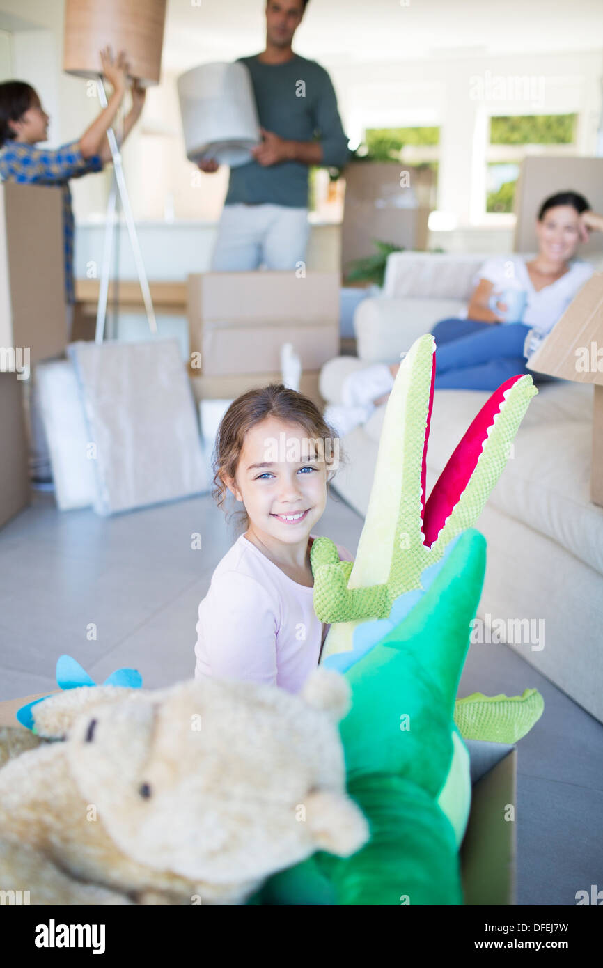 Girl playing with stuffed animals in new house Stock Photo - Alamy