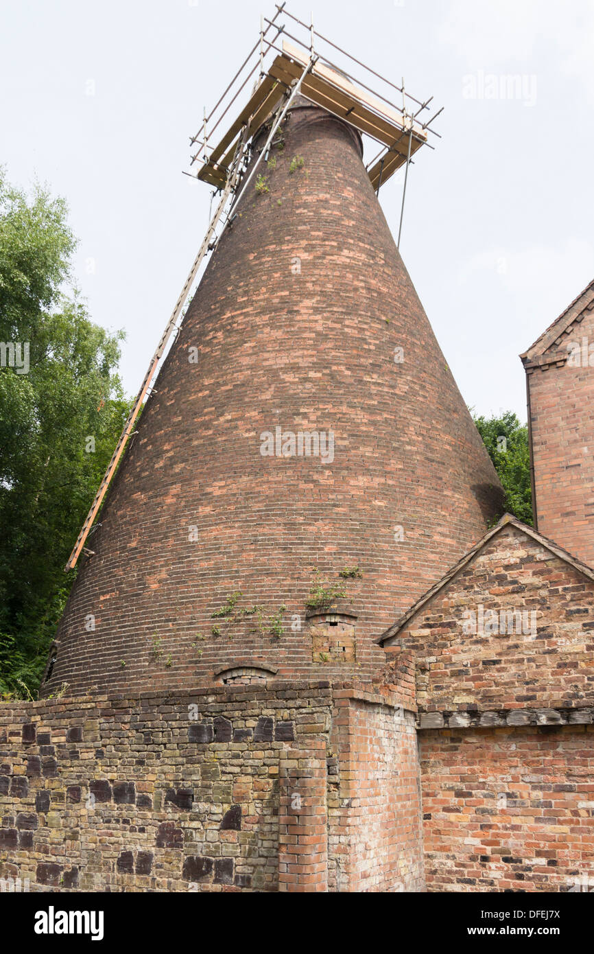 Old pottery bottle kiln exterior, undergoing maintenance, at Coalport