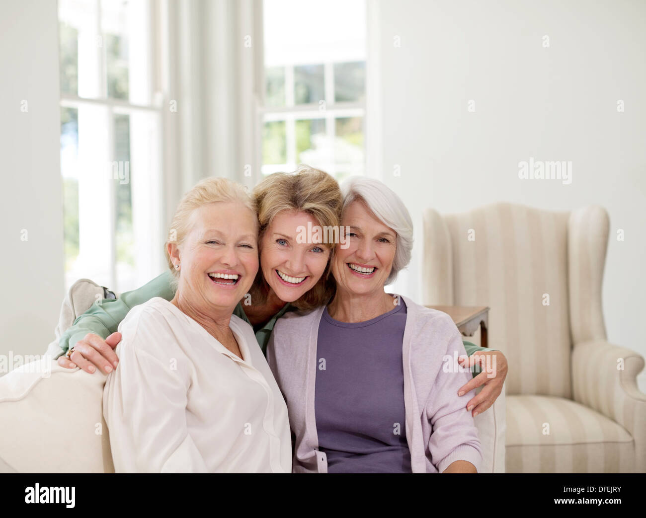 Portrait of smiling senior women in livingroom Stock Photo