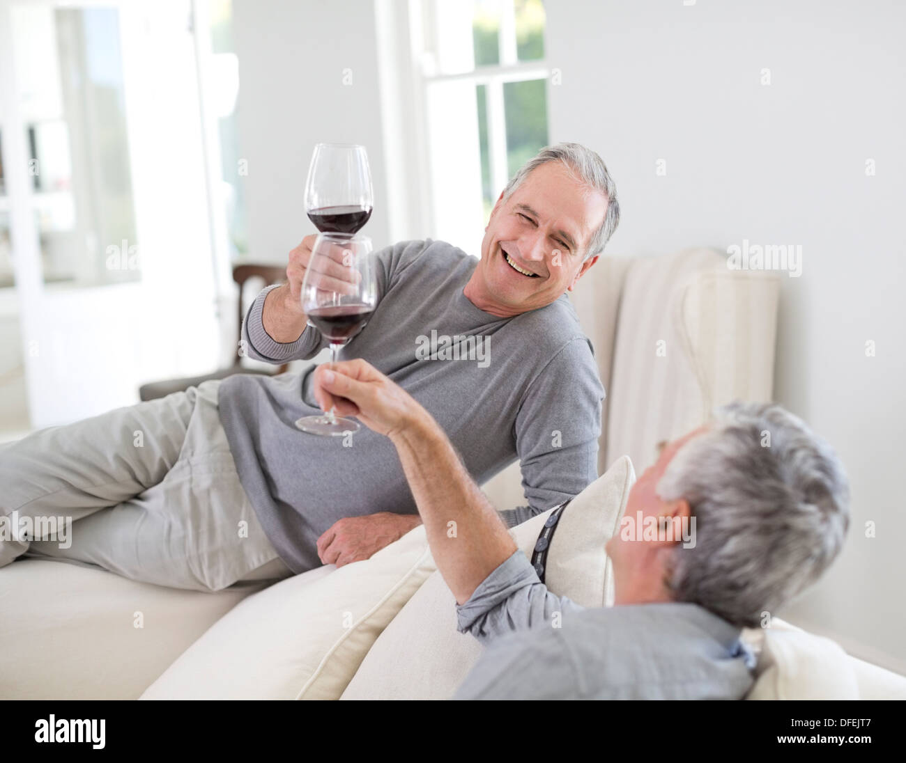 Senior men toasting wine glasses Stock Photo