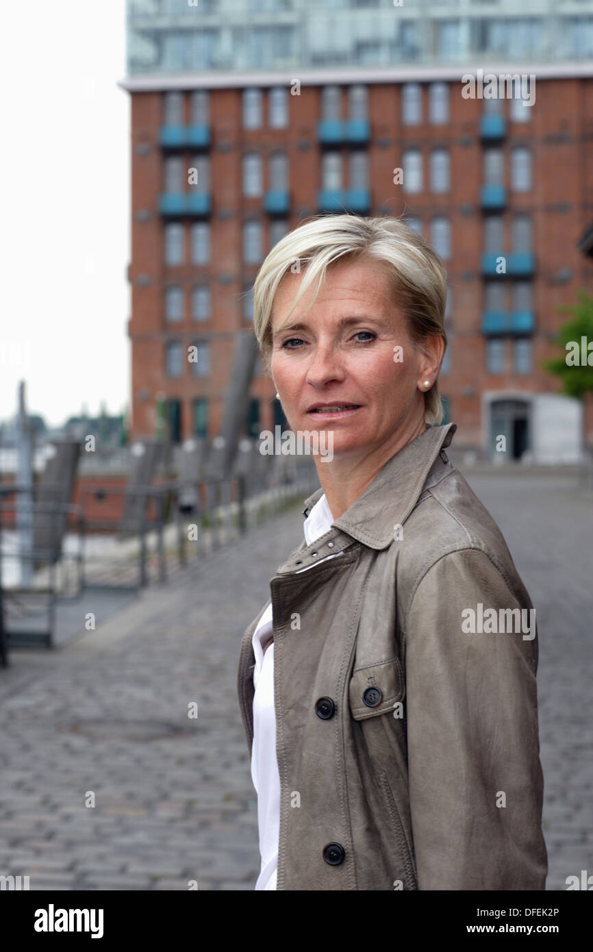 Blond Haired Executive Woman Turning Her Head Around To The Camera