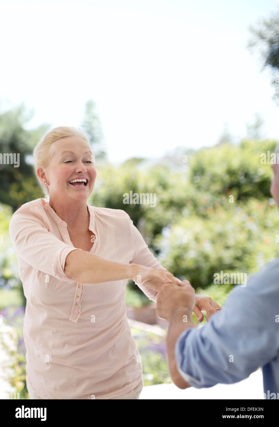 Senior couple dancing on patio Stock Photo