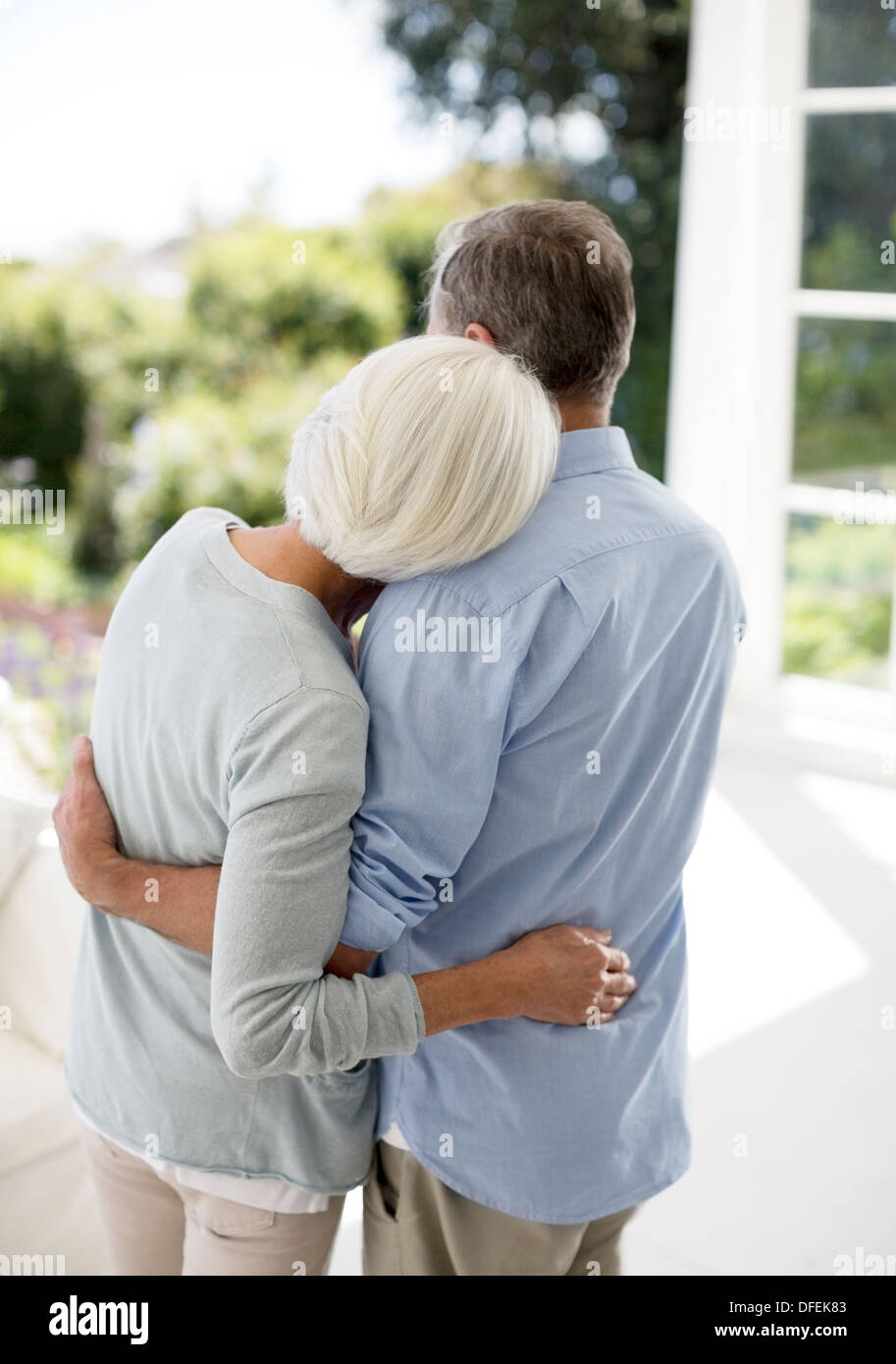 Senior couple hugging on patio Stock Photo