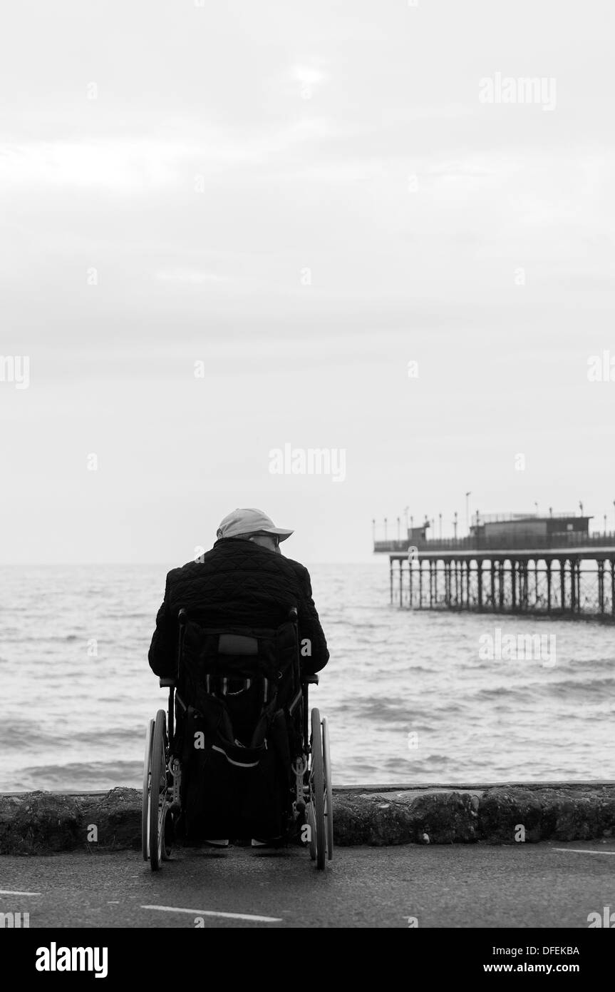 Silhouette of a Disabled Man in a Wheelchair with a Fishing Rod in
