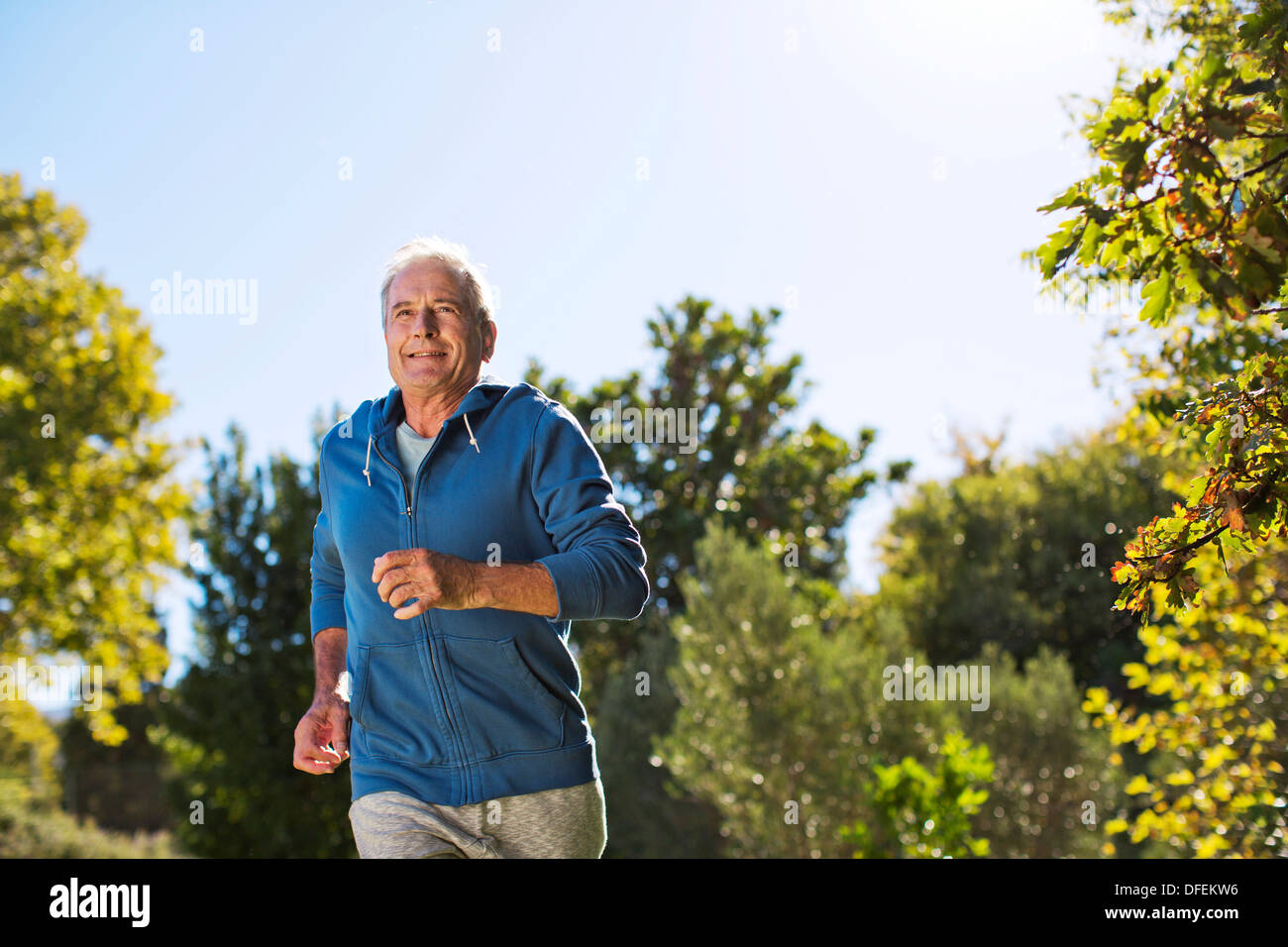 Senior man running in park Stock Photo