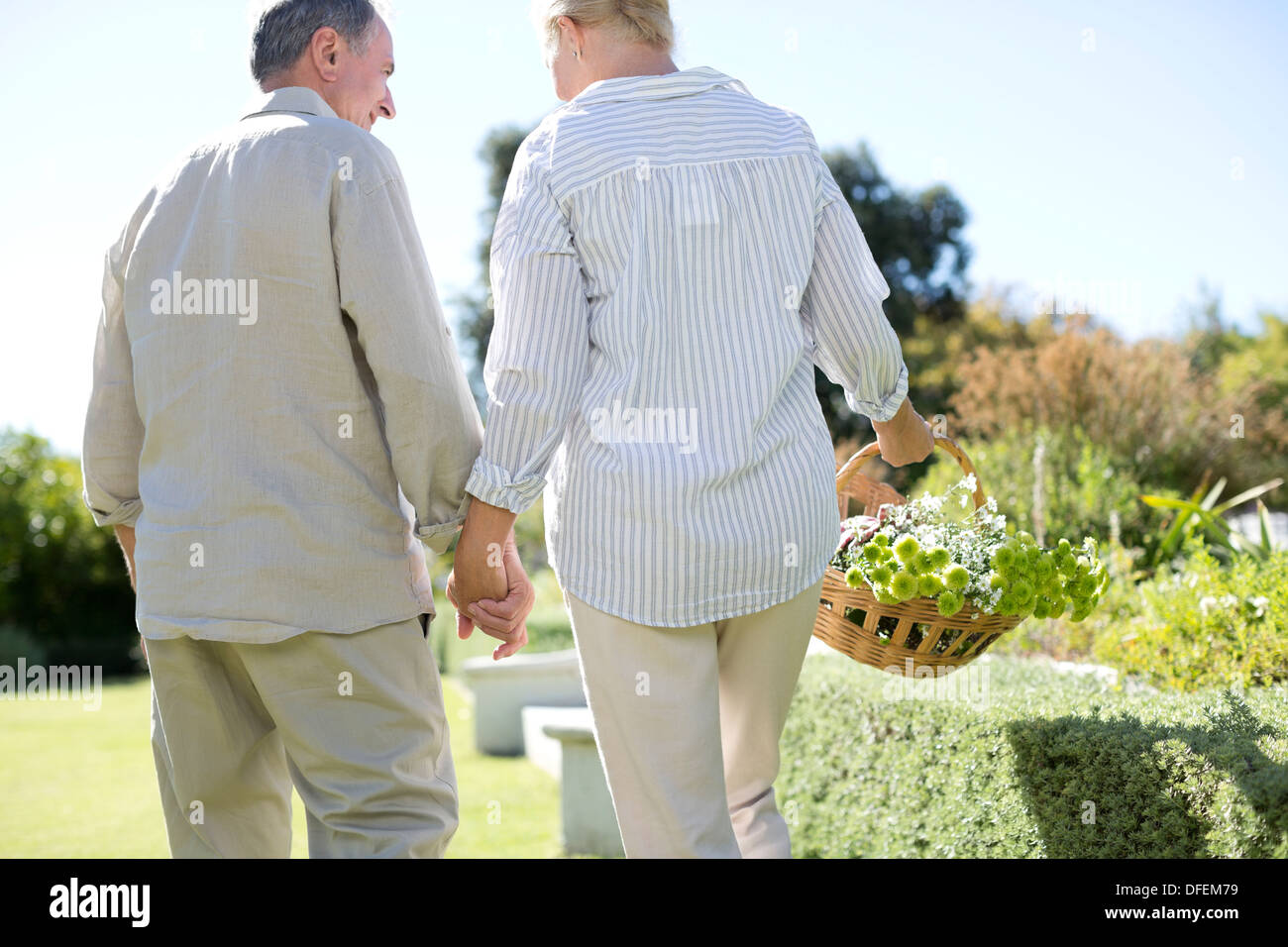 Senior couple holding hands in garden Stock Photo