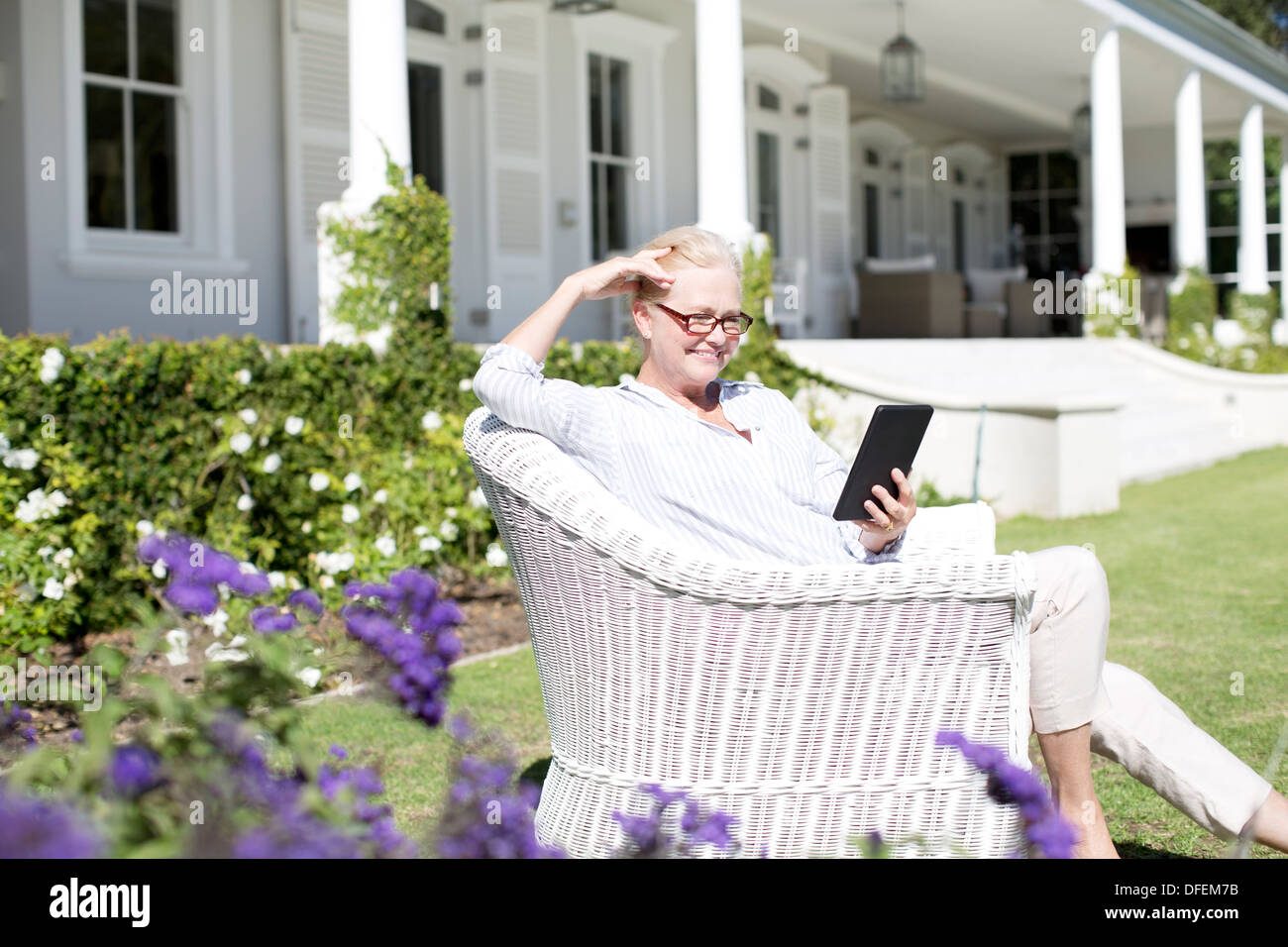 Senior woman using digital tablet in garden Stock Photo