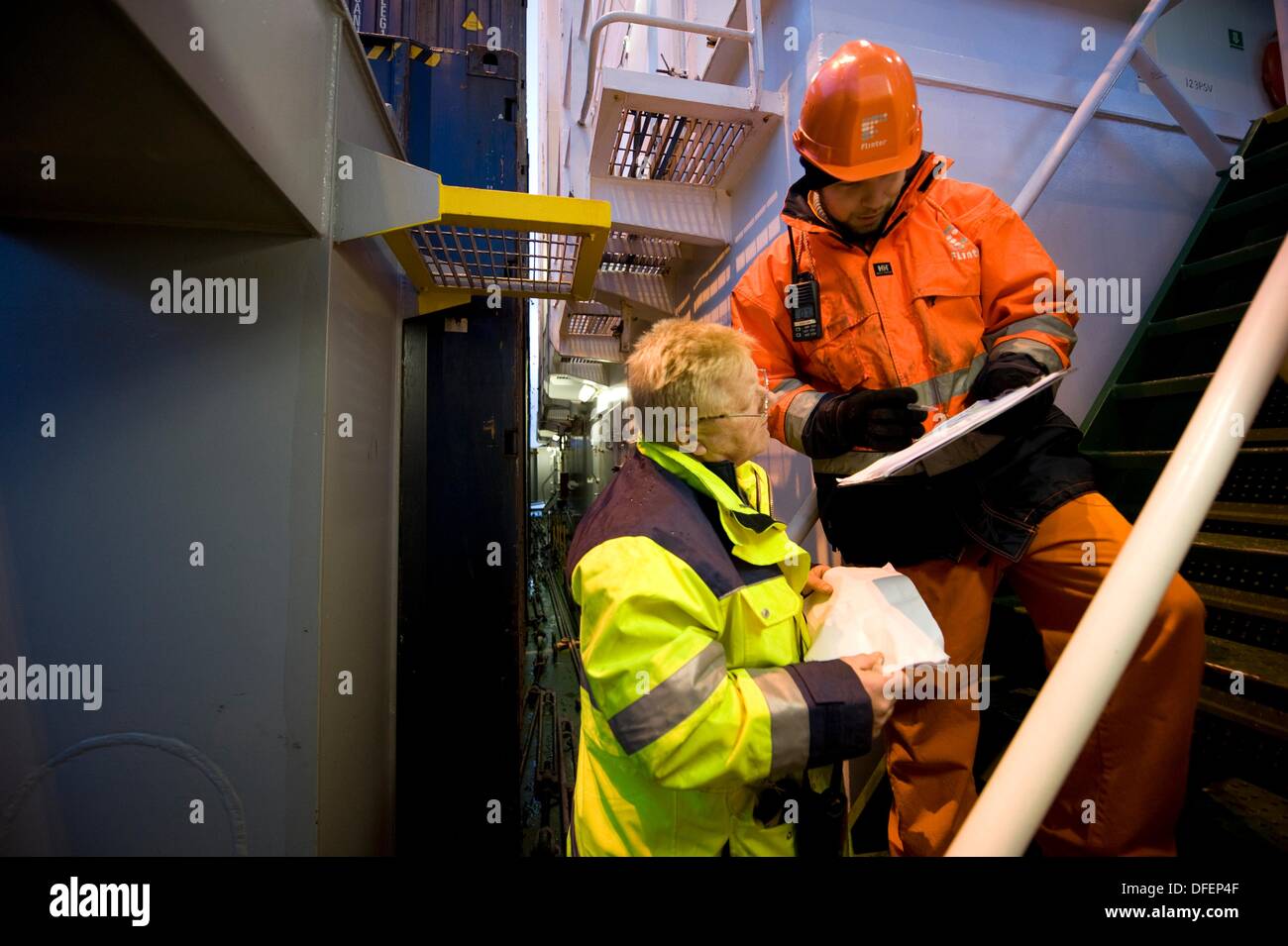 The second officer and the loading master from the dock consult on