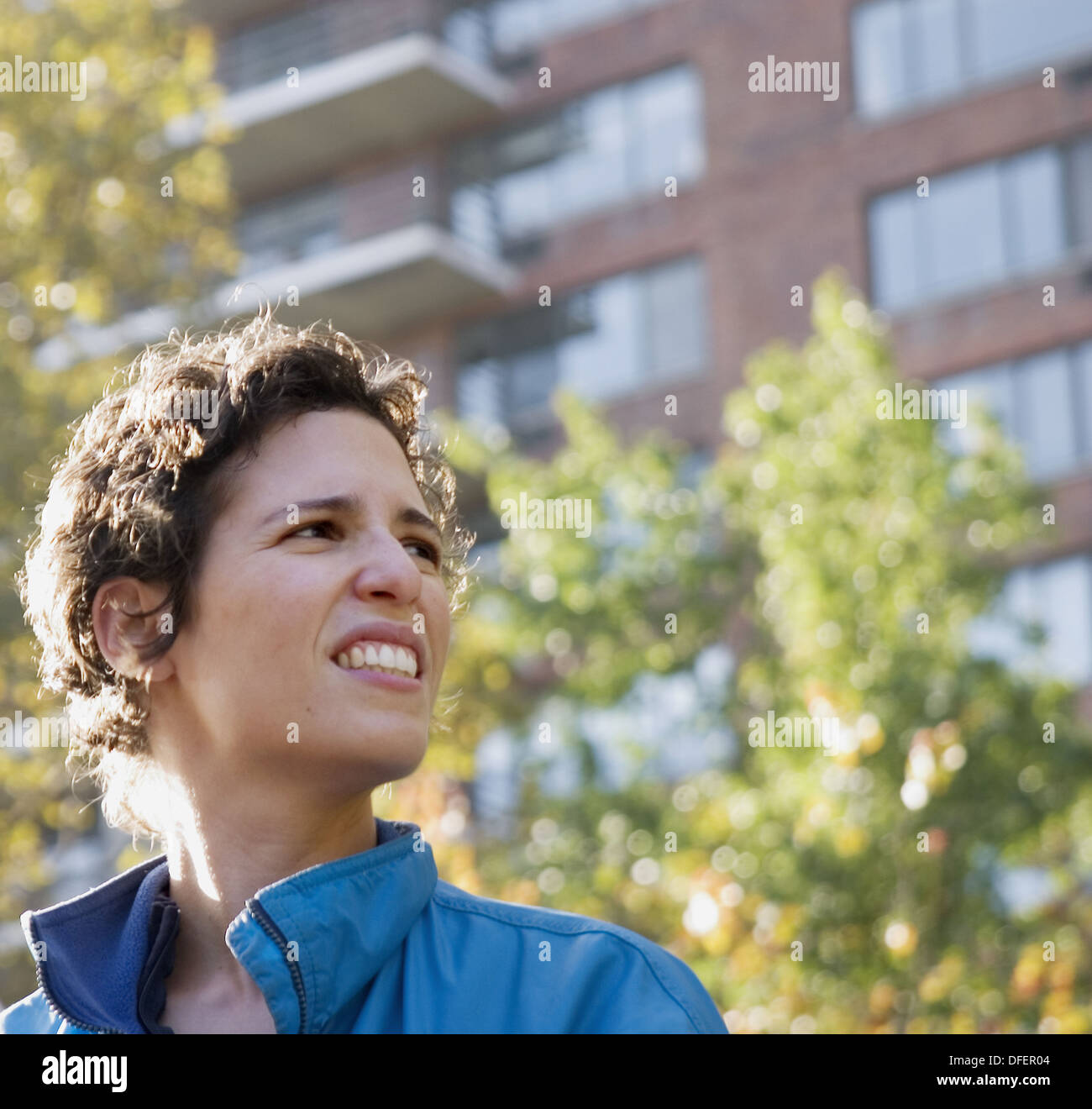 33yearold woman looking up in front of an apartment building in New