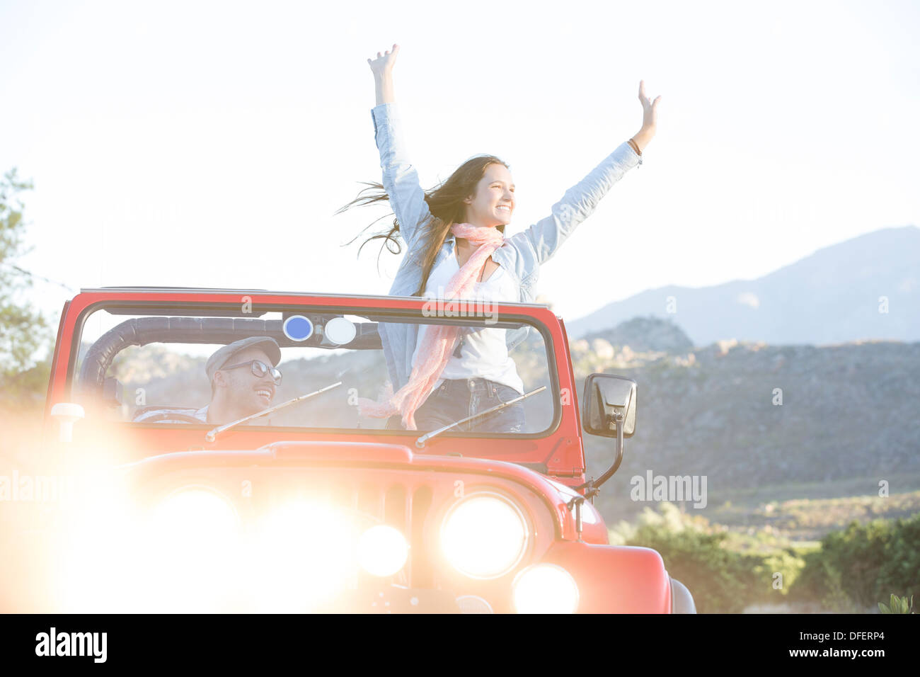 Woman cheering in sport utility vehicle Stock Photo