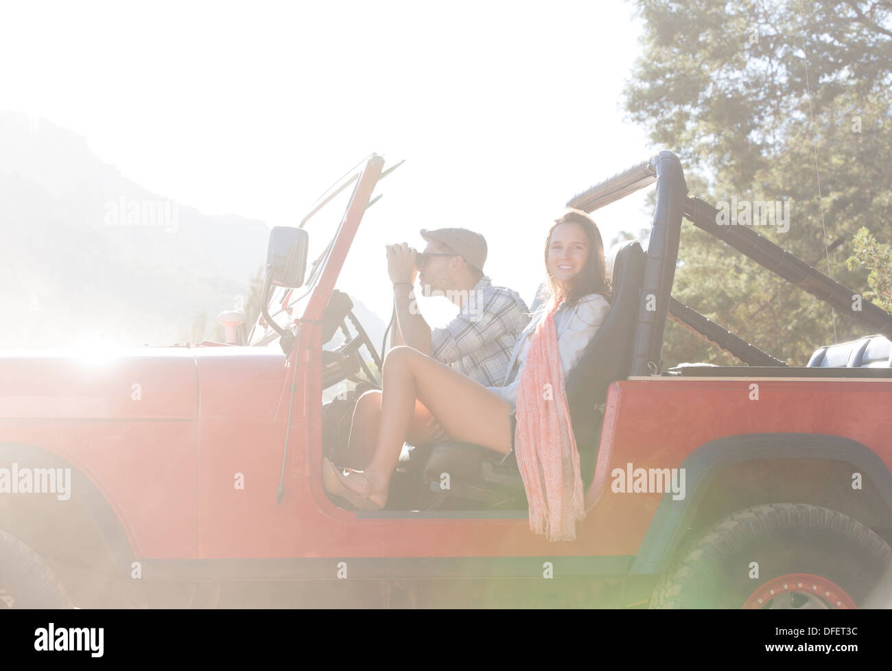 Couple sitting in sport utility vehicle Stock Photo