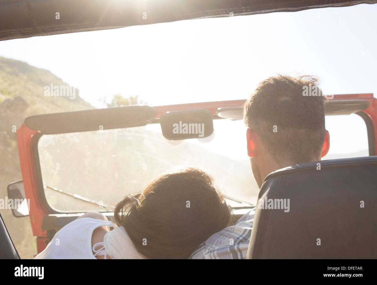 Couple driving sport utility vehicle Stock Photo