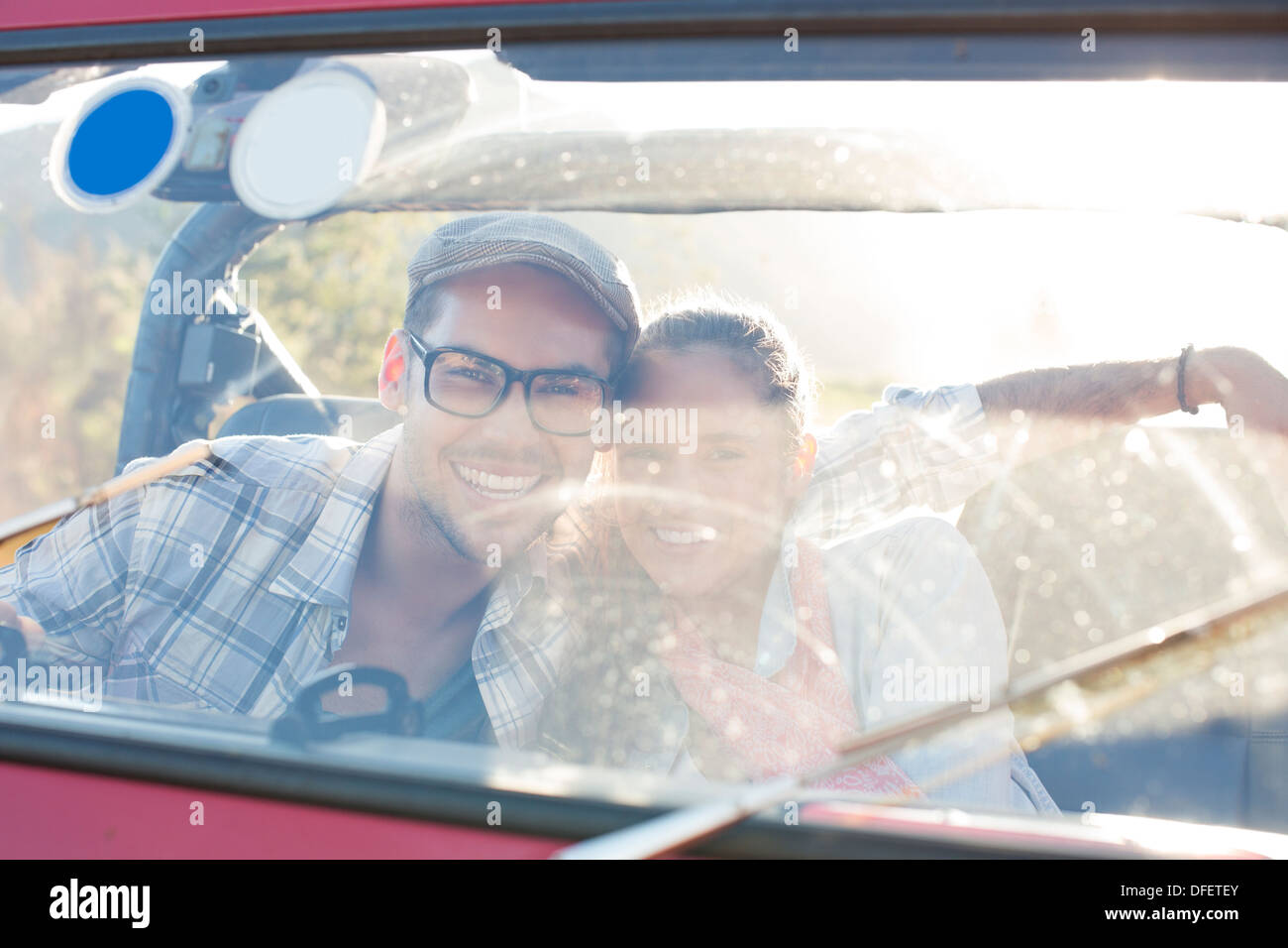 Portrait of smiling couple in sport utility vehicle Stock Photo