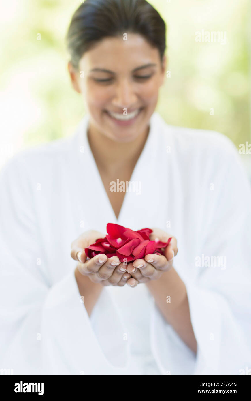 Woman holding handful of flower petals Stock Photo