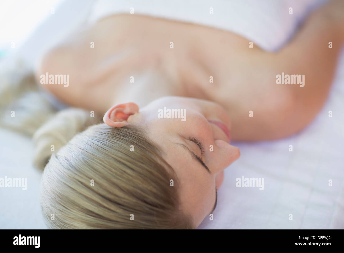 Woman laying on massage table at spa Stock Photo