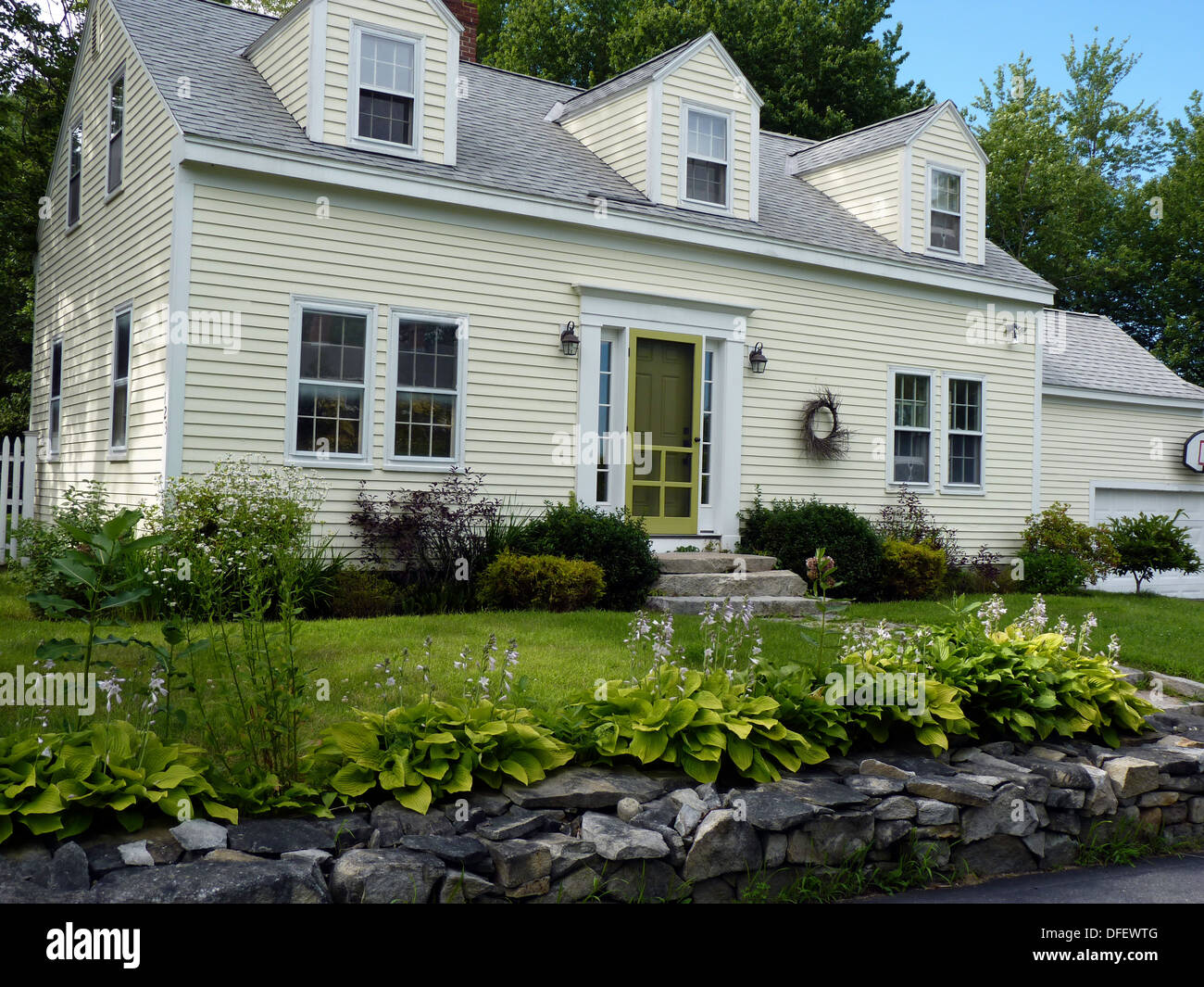 Cape style house with yellow clapboard in Yarmouth Maine, USA Stock Photo