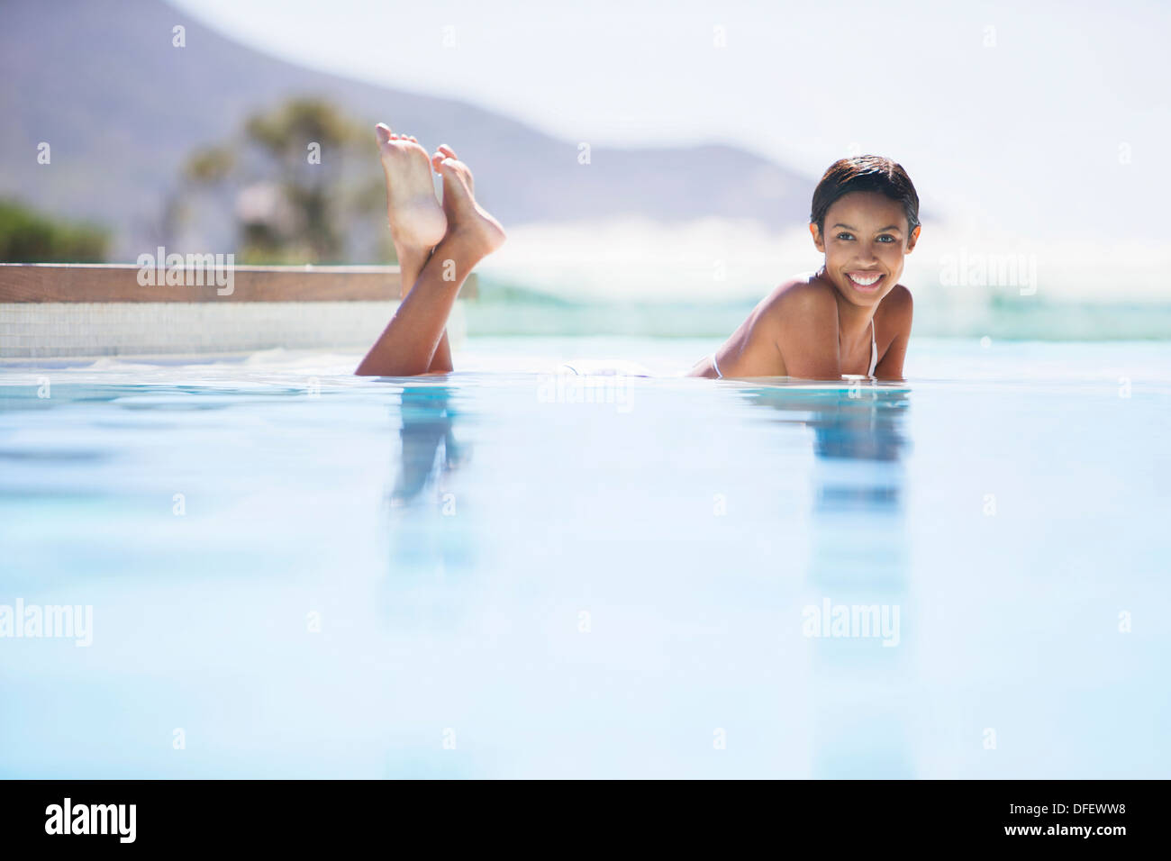 Couple relaxing in swimming pool Stock Photo