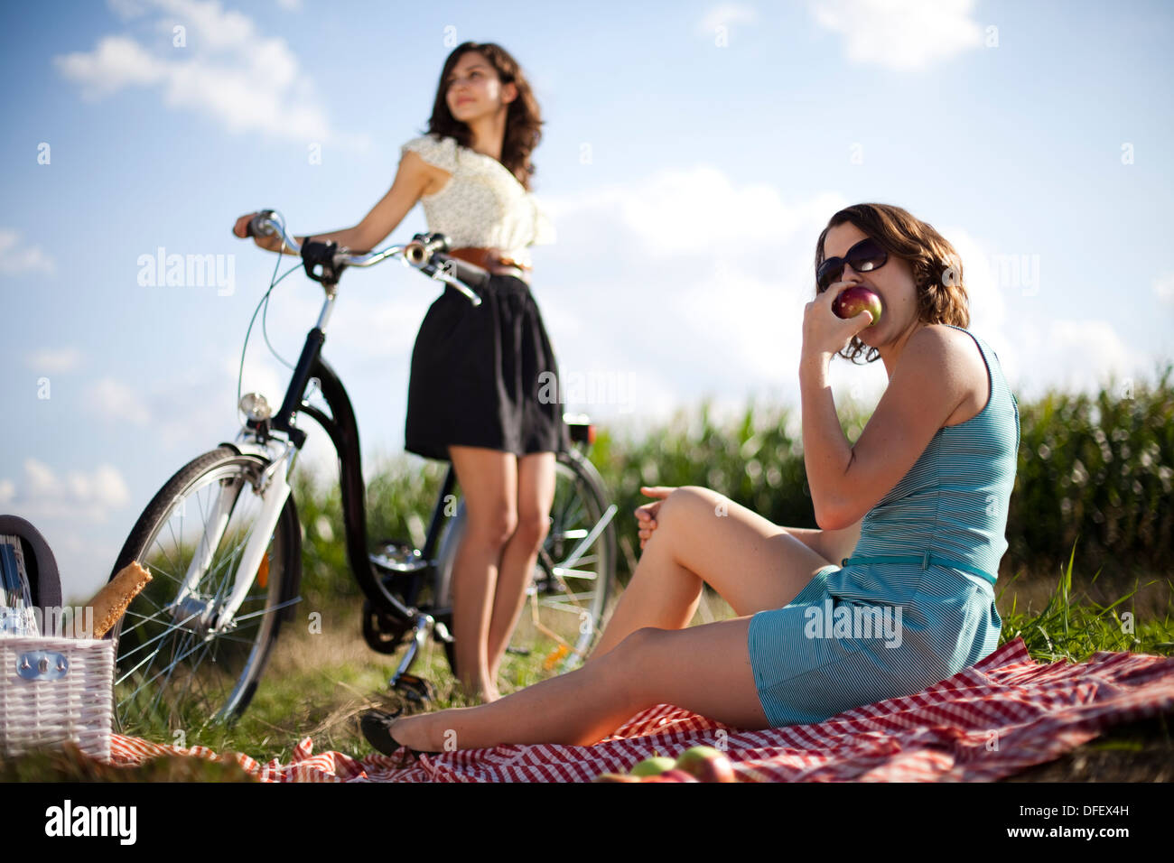 Young women riding bike Stock Photo - Alamy