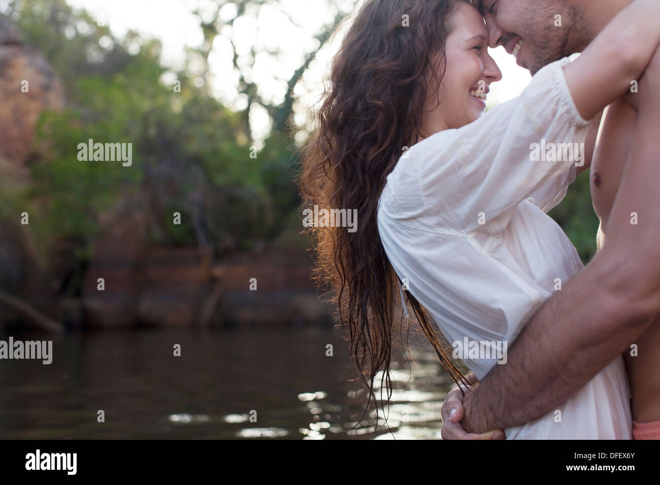 Couple hugging at riverside Stock Photo - Alamy