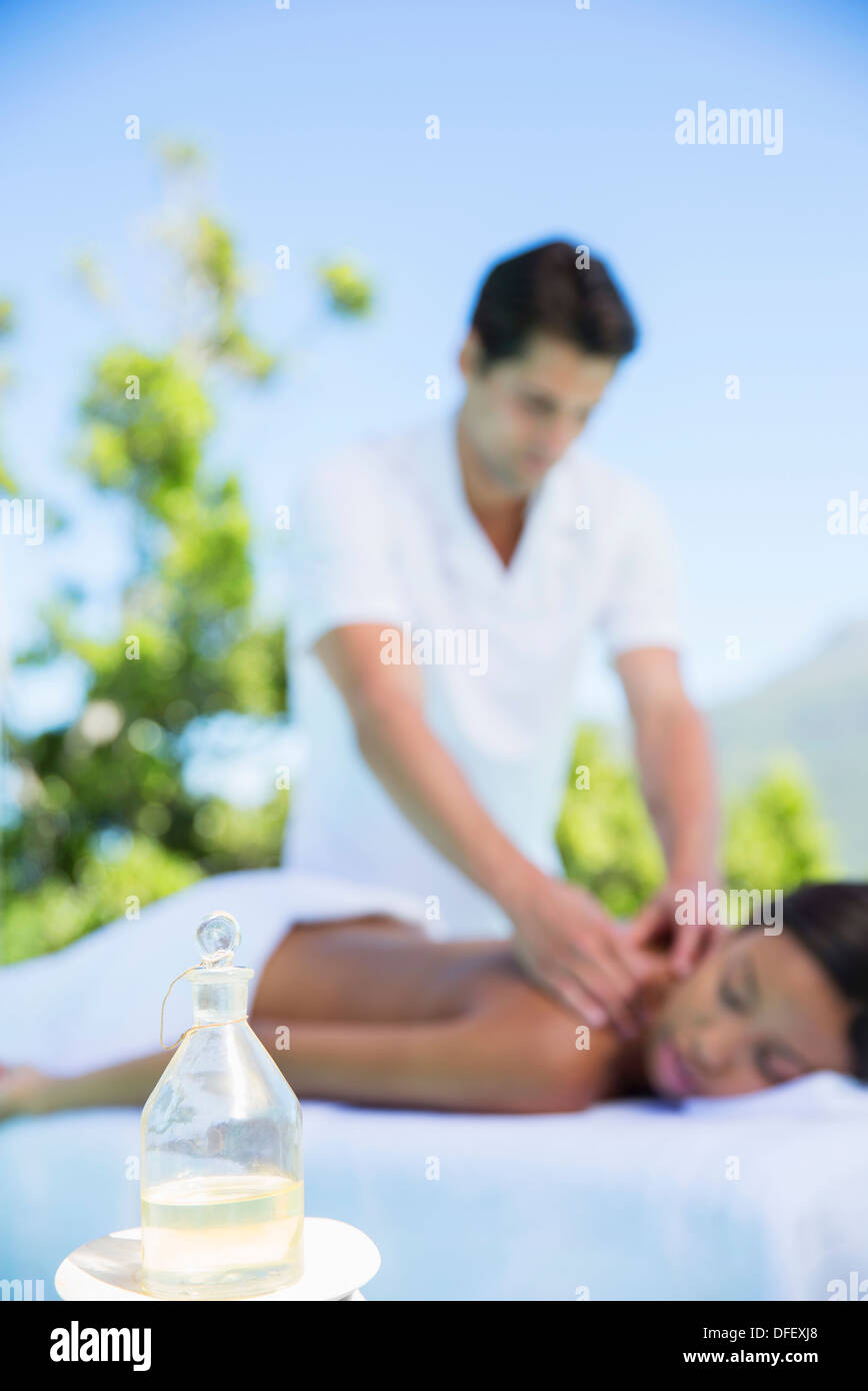 Woman receiving massage on spa patio Stock Photo