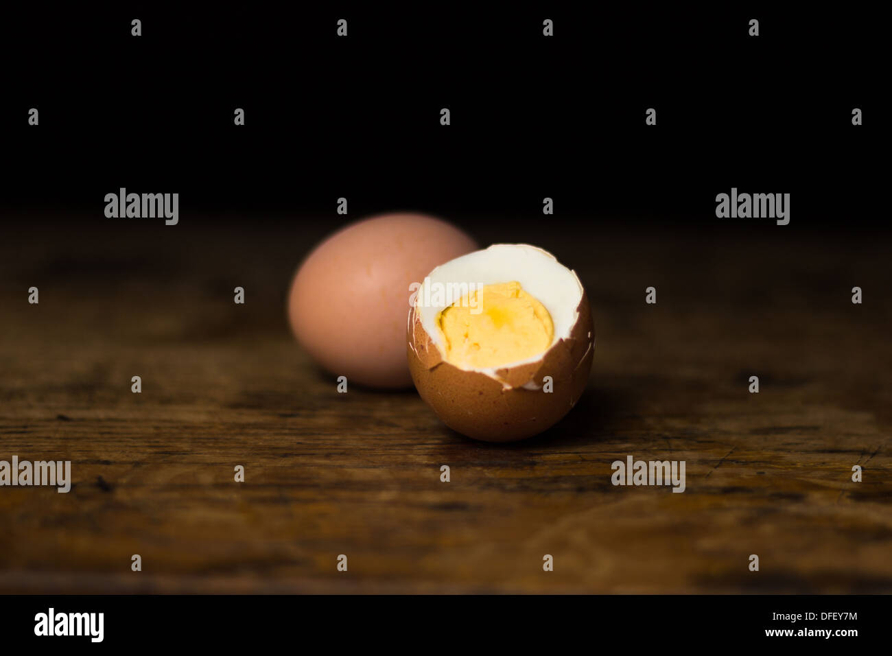 Two hardboiled eggs on wood surface Stock Photo