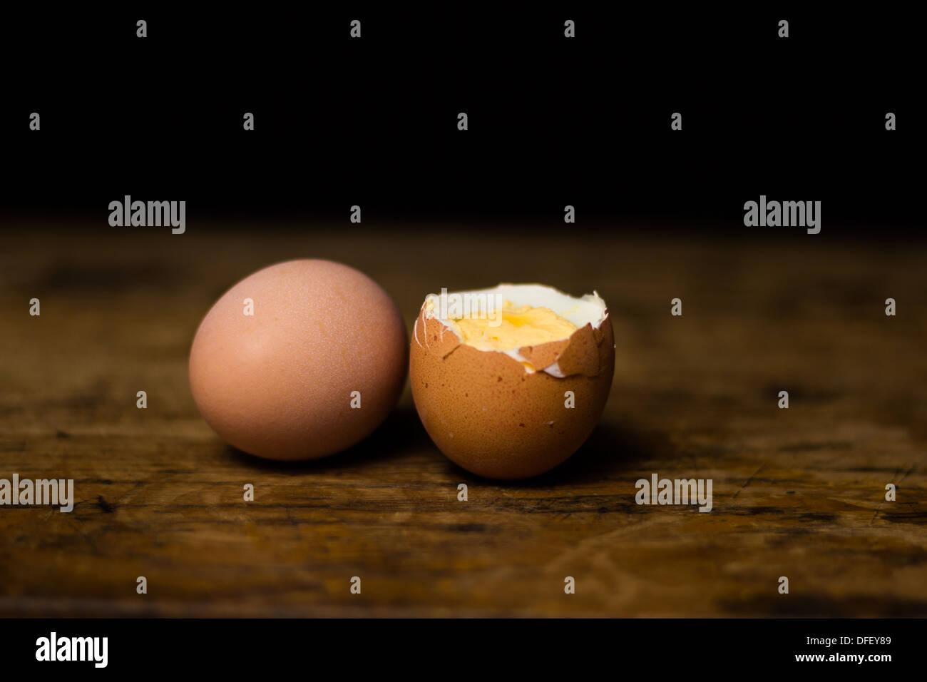 Two hardboiled eggs on wood surface Stock Photo