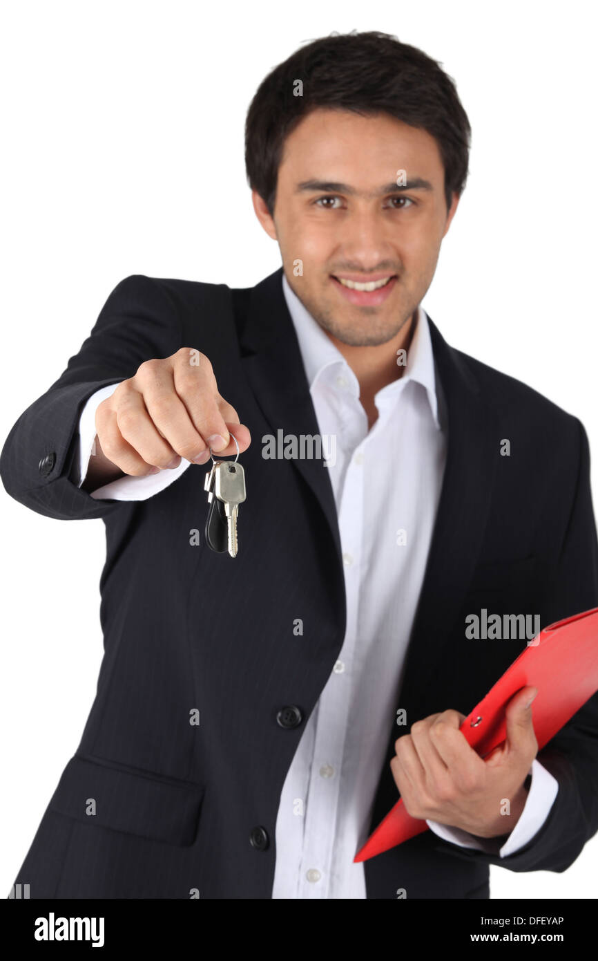 Estate agent offering house keys Stock Photo Alamy