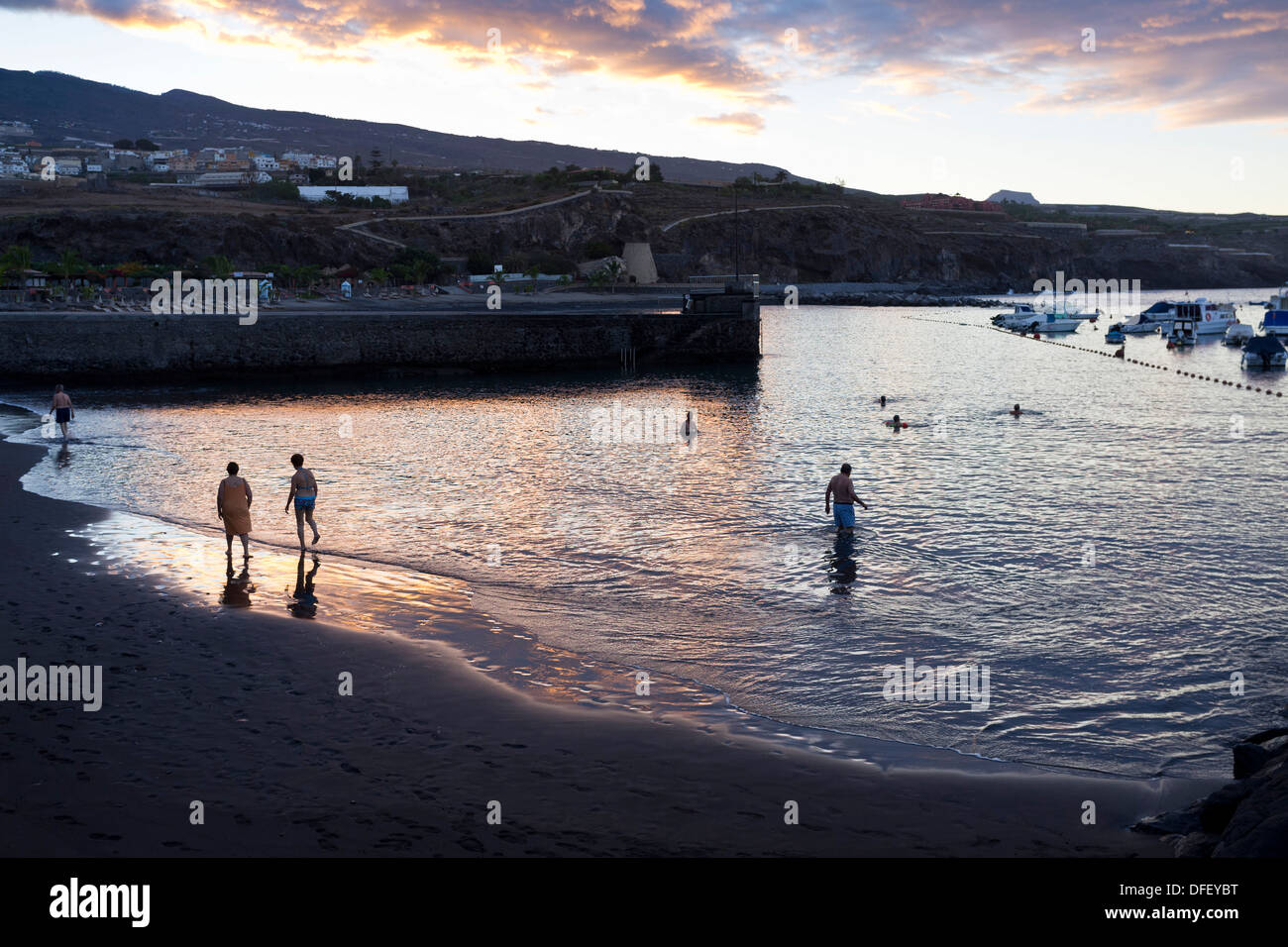 Early morning swimmers at the small beach in Playa San Juan, tenerife, canary islands, Spain, Spanish, Stock Photo