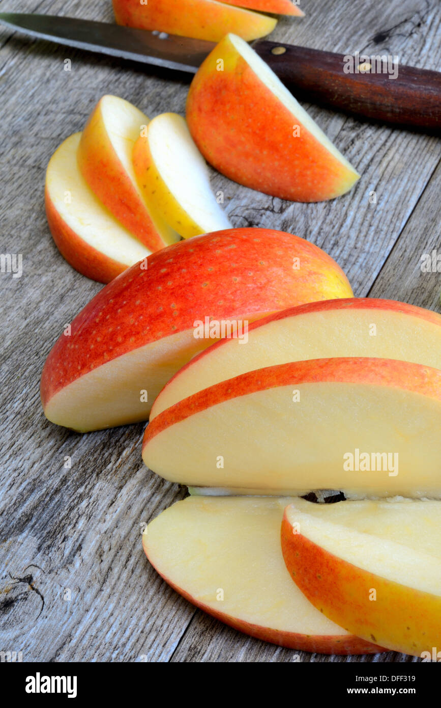 sweet delicious royal gala apple sliced on wooden table Stock Photo