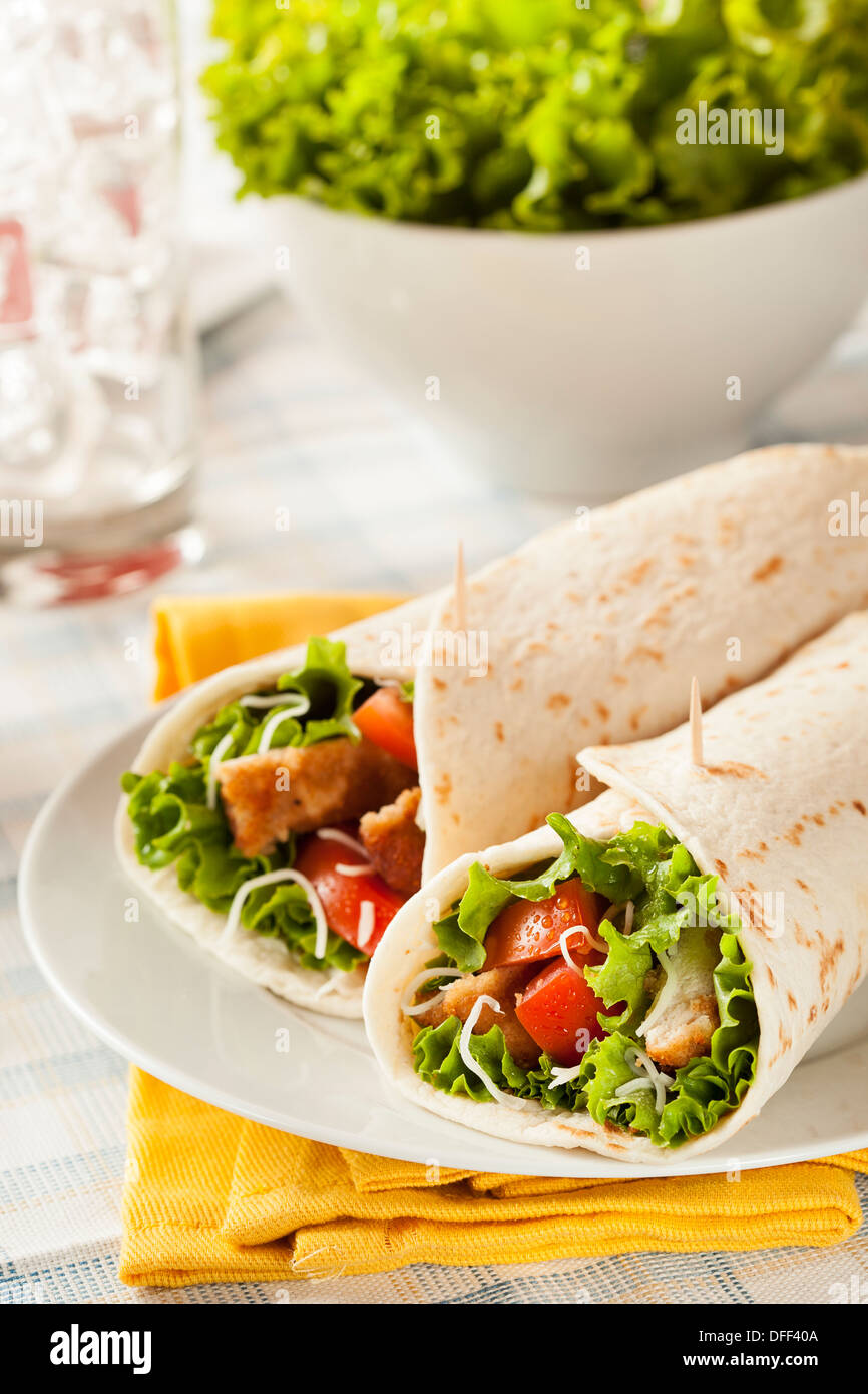 Breaded Chicken in a Tortilla Wrap with Lettuce and Tomato Stock Photo