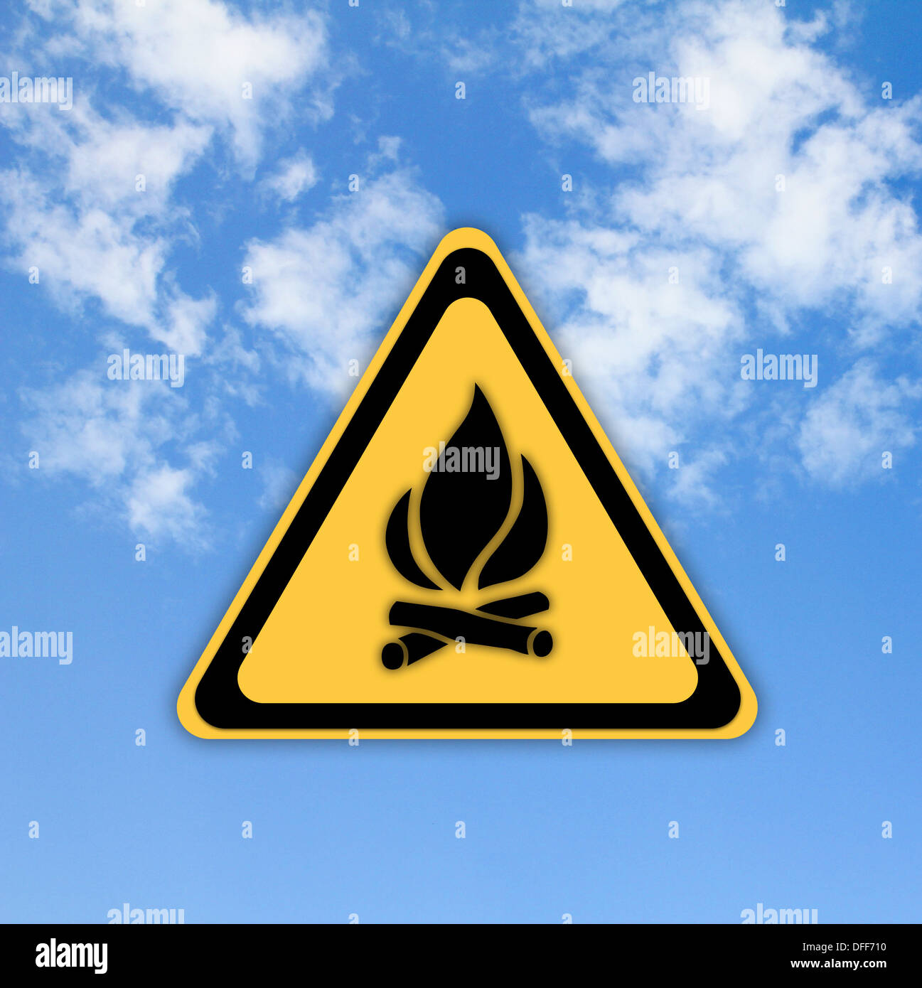 Glossy Fire danger sign on beautiful sky background. Stock Photo