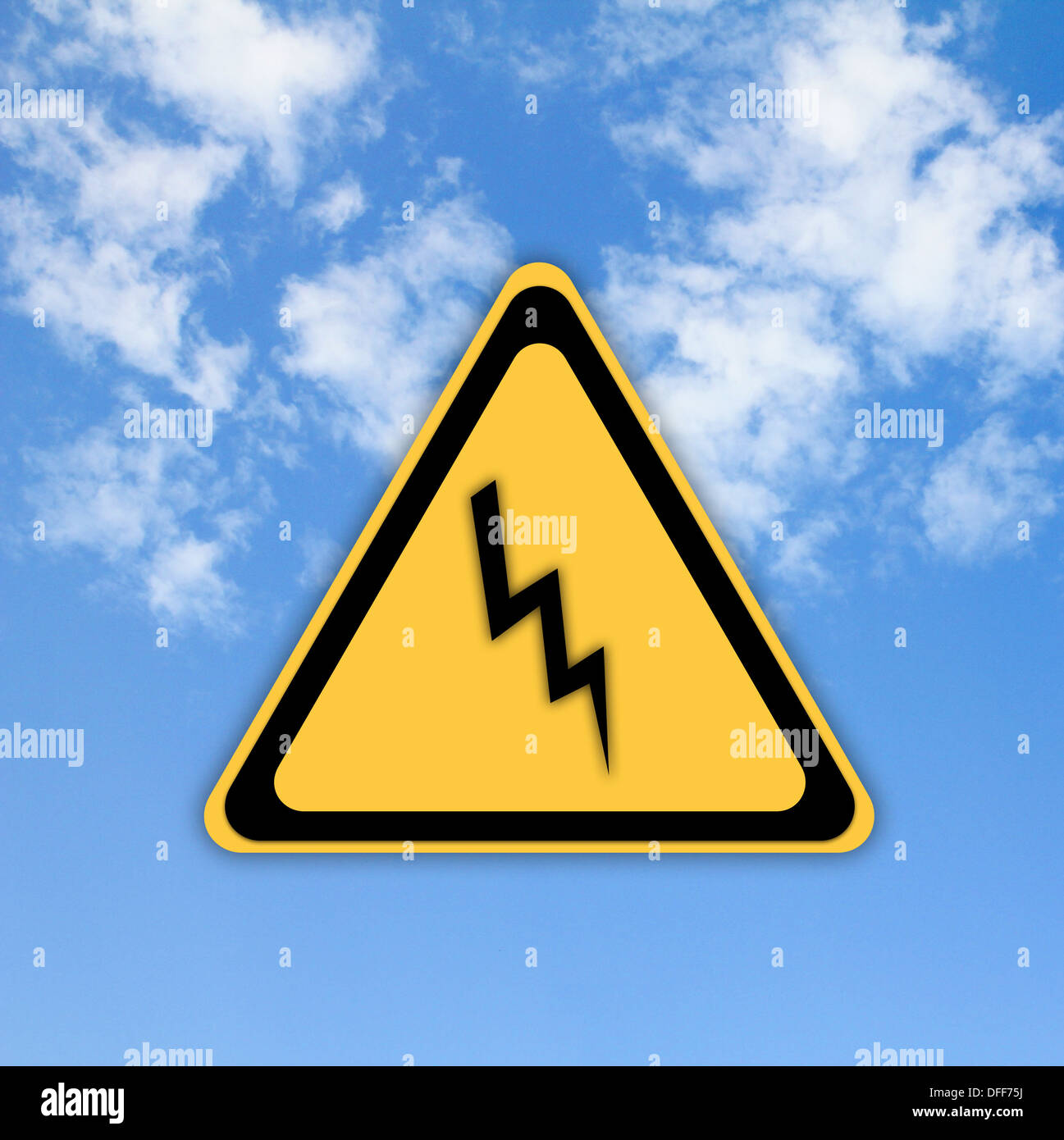 Danger high voltage sign on beautiful sky background. Stock Photo