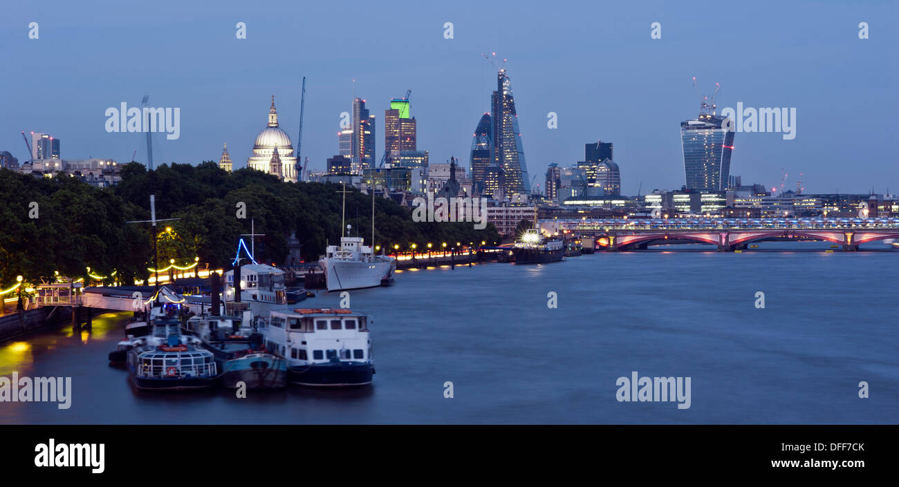 Panoramic view of the skyline of London from the river Thames. The City, St Pauls' Cathedral, new skyscrapers and boats moored. Stock Photo