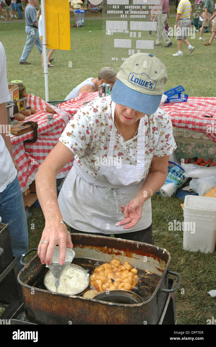 Deep frying kettle cakes funnel cakes for sale at fair in deep fryer