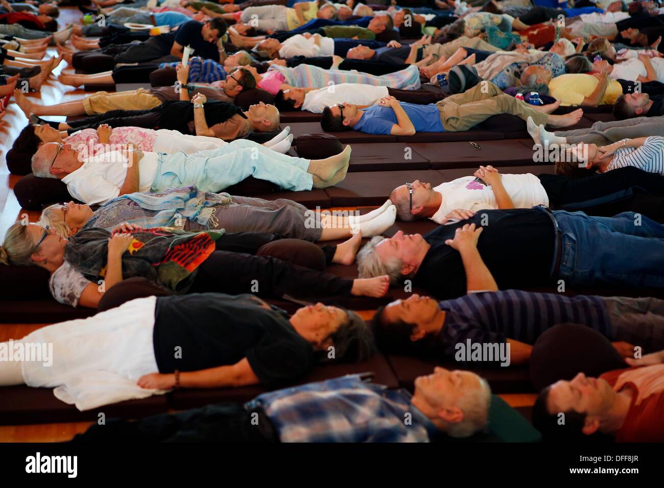 Batesville, Mississippi, USA. 28th Sep, 2013. September 27, 2013 - People lay in silence on the floor of the Magnolia Grove Monastery Meditation Hall during an event called total relaxation which takes place directly after lunchtime, Friday afternoon in Batesville, Mississippi. Nearly one-thousand people took part in the retreat to listen to the teachings of Thich Nhat Hanh, a Vietnamese Zen Buddhist monk, teacher, author, poet and peace activist, who was visiting the monastery. © Brad Vest/The Commercial Appeal/ZUMAPRESS.com/Alamy Live News Stock Photo