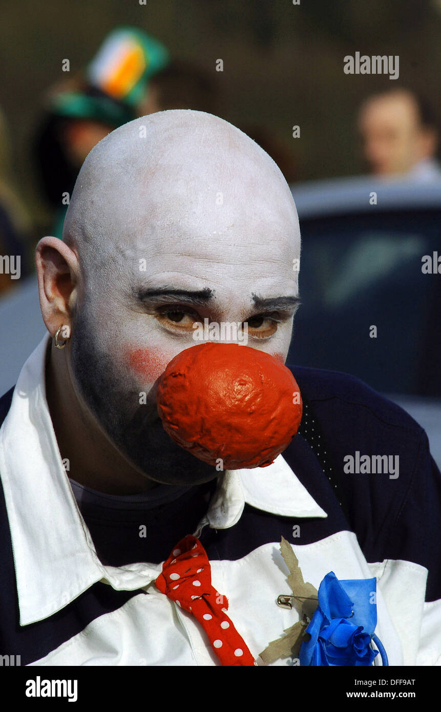 Clown with large red nose and white face at Saint Patrick's Day parade, Derry, Londonderry, Northern Ireland. Stock Photo
