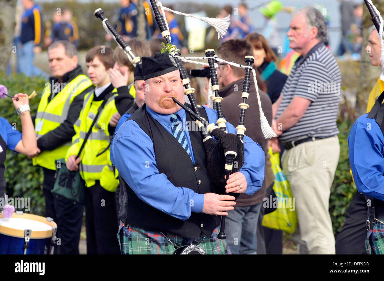 Man, in tartan, playing the bagpipes at Saint Patrick's Day parade in Derry, Londonderry, Northern Ireland. Stock Photo