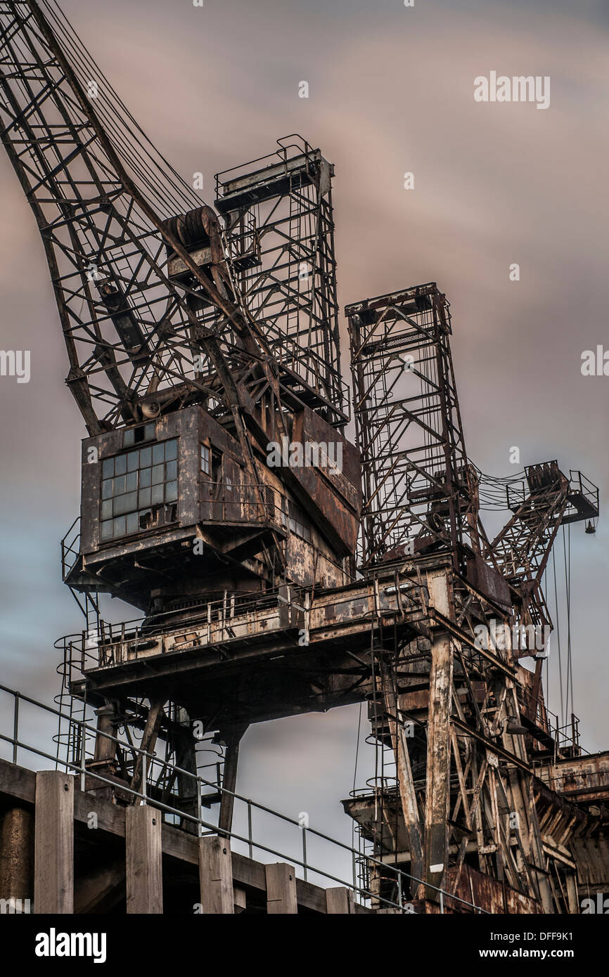 Two rusting cranes by Battersea Power Station Stock Photo