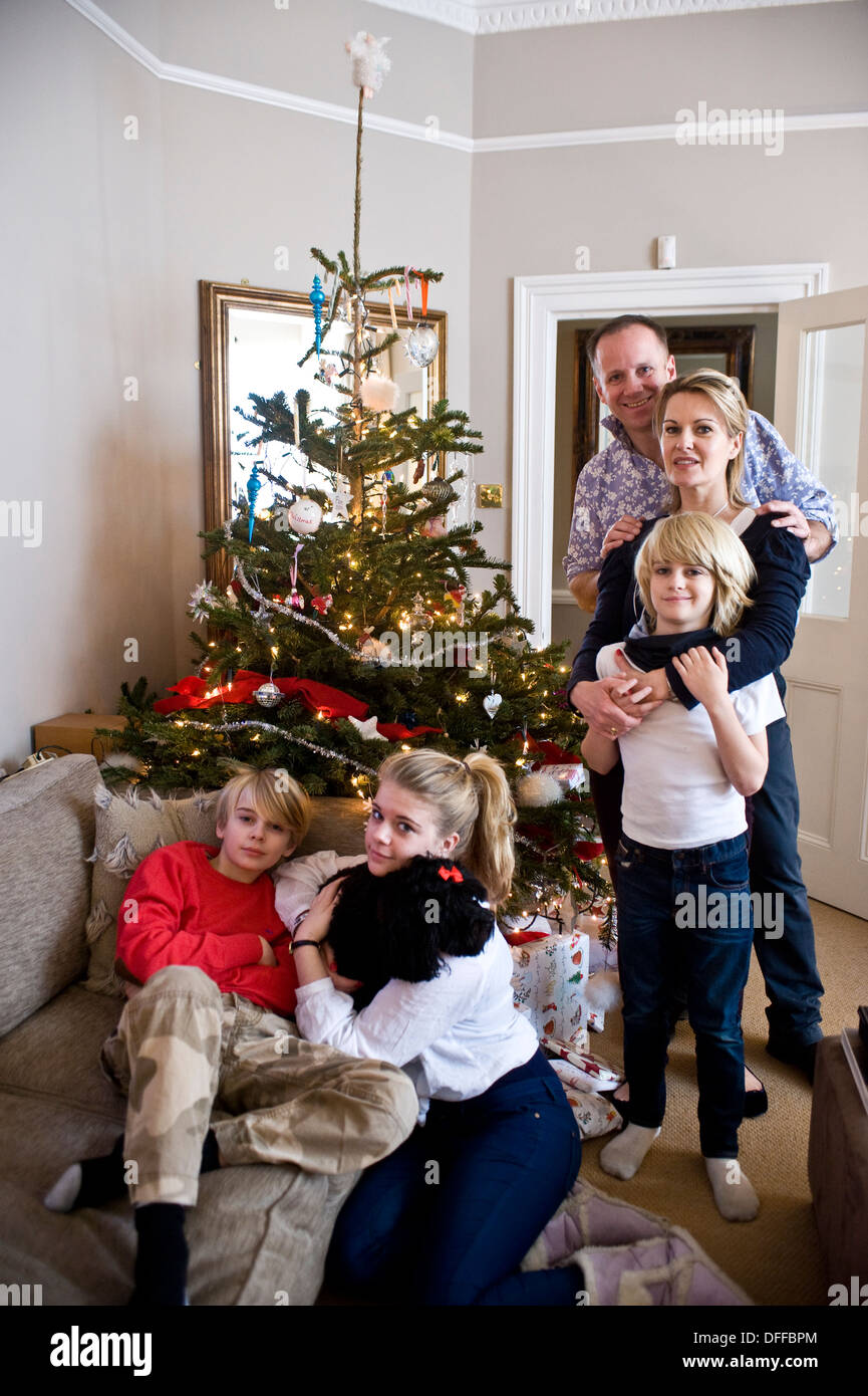 A family around a Christmas tree Stock Photo